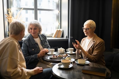 elderly-women-drinking-coffee-and-talking-during-gathering