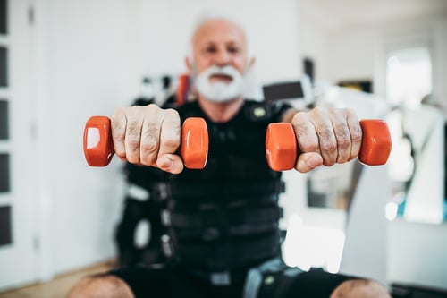 good-looking-positive-senior-man-doing-exercises-electrical-muscular-stimulation-suit