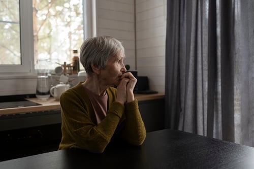 medium-shot-senior-woman-sitting-table