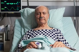 portrait-of-sick-senior-man-patient-resting-in-hospital-bed-breathing-with-help-from-oxygen-mask-because-of-lungs-infection-having-oximeter-attached-on-finger